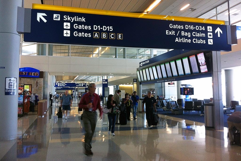 Travelers walk through Dallas/Fort Worth Airport.