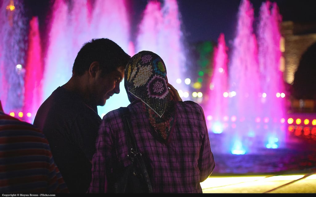 Singapore and Malaysia are MasterCard and CresentRatings' picks for top destinations Muslim travelers should visit. Pictured, a Muslim couple in front of the fountain of the main square of Istanbul.
