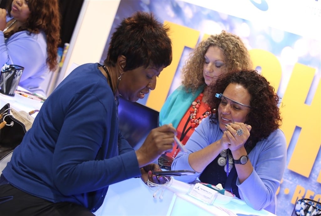 Dahlia El Gazzar (right), CEO of The Meeting Pool, operates the TechBar at the IBTM America meeting industry trade show /