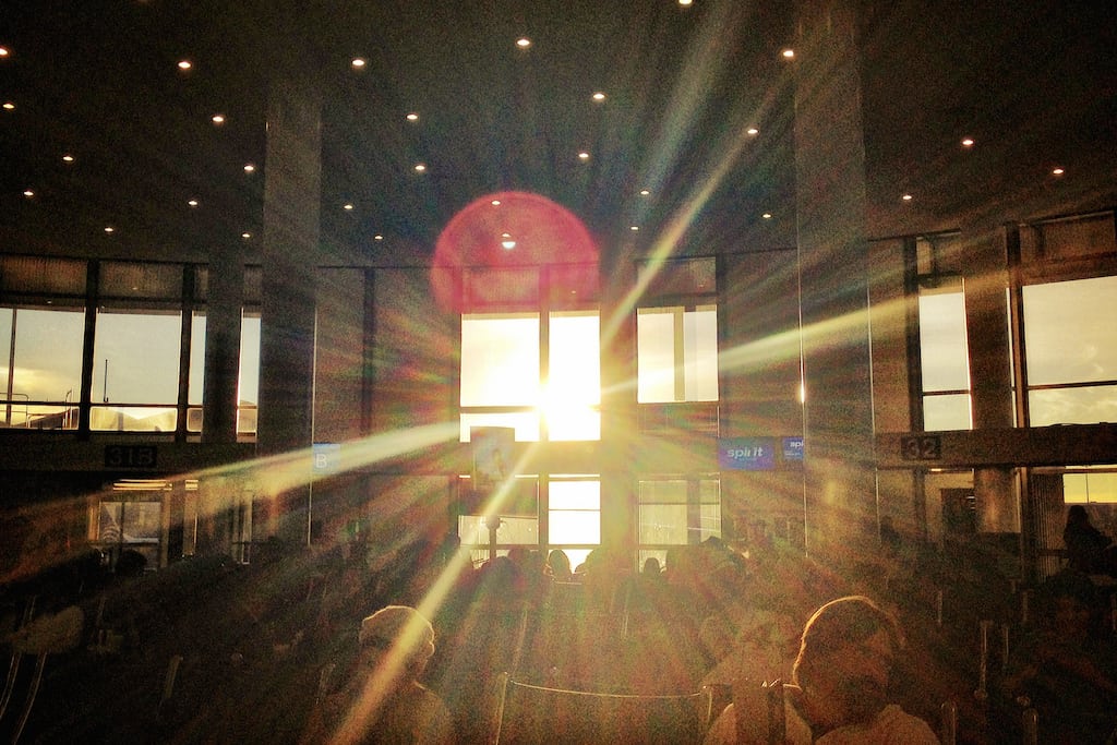 The sun shines through a window at Los Angeles International Airport. 