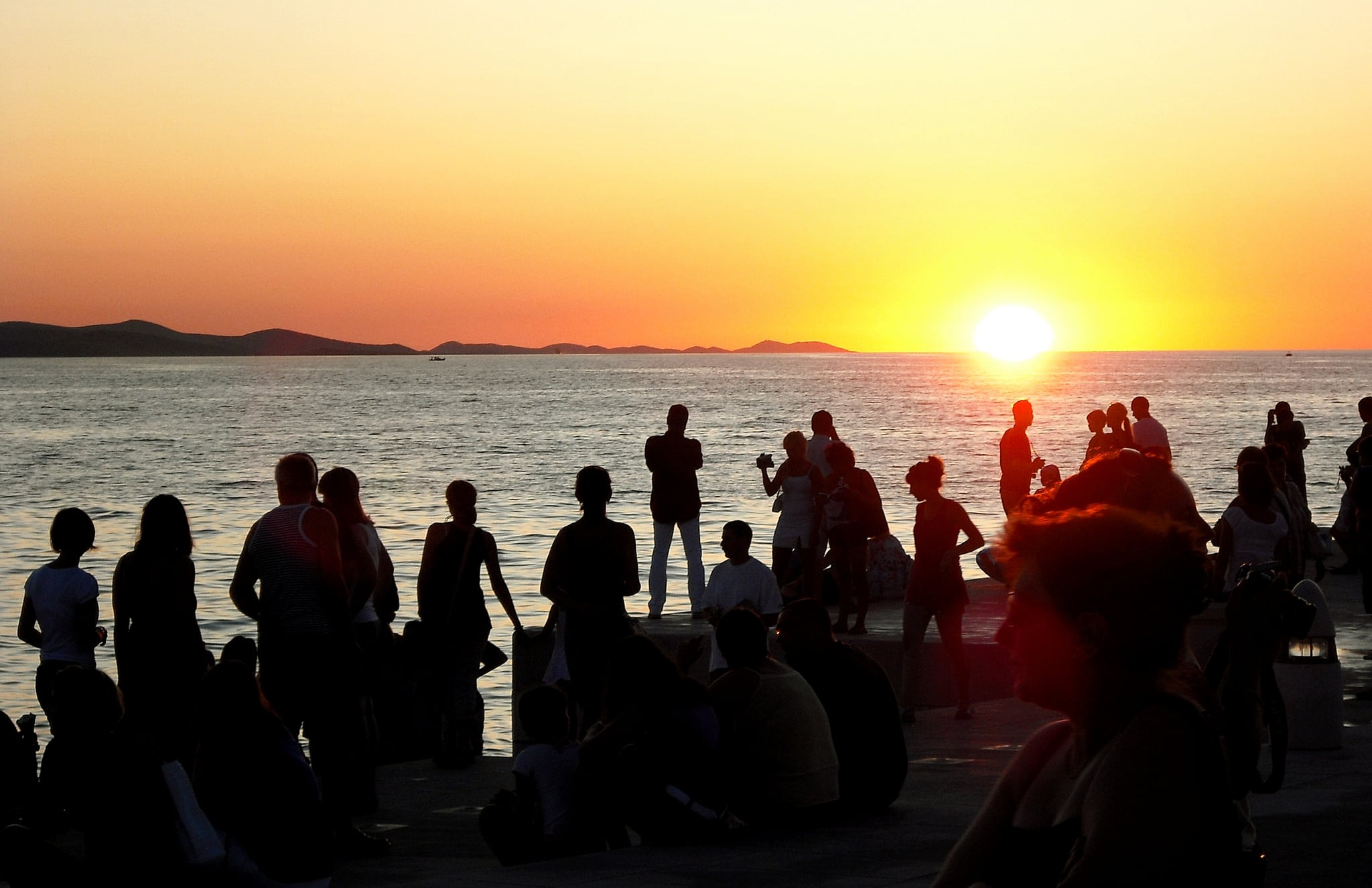 Tourists watch the sunset in Zadar, Croatia. 