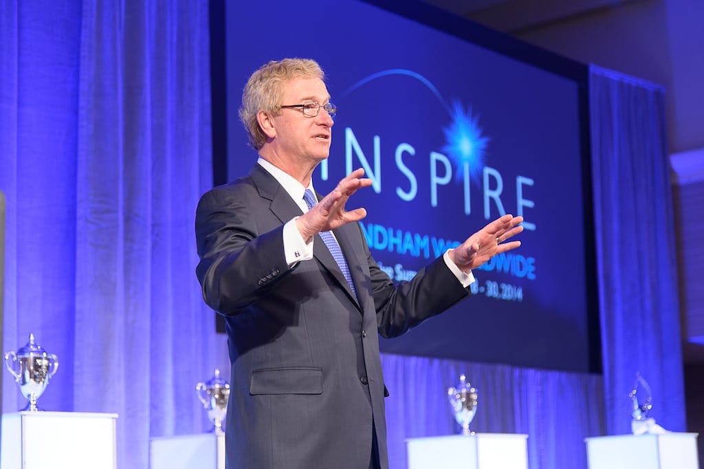 Wyndham Worldwide CEO Stephen Holmes speaks at a corporate event.