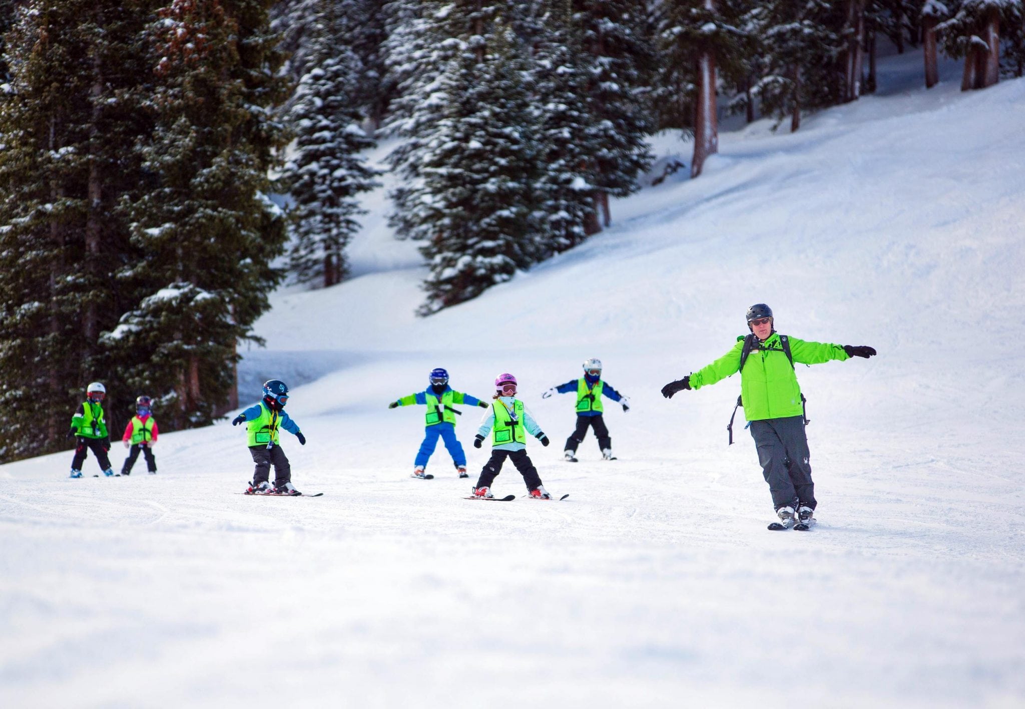 A group of children at Arapahoe  Basin practicing their ski moves with an instructor. Family travelers are more likely to stay in alternative accommodations than singles or couples. 