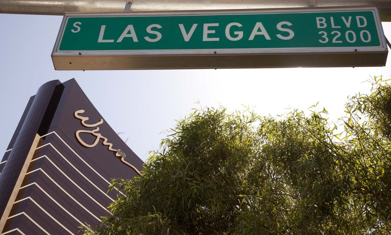 The Wynn Las Vegas is framed under a Las Vegas Boulevard street sign.