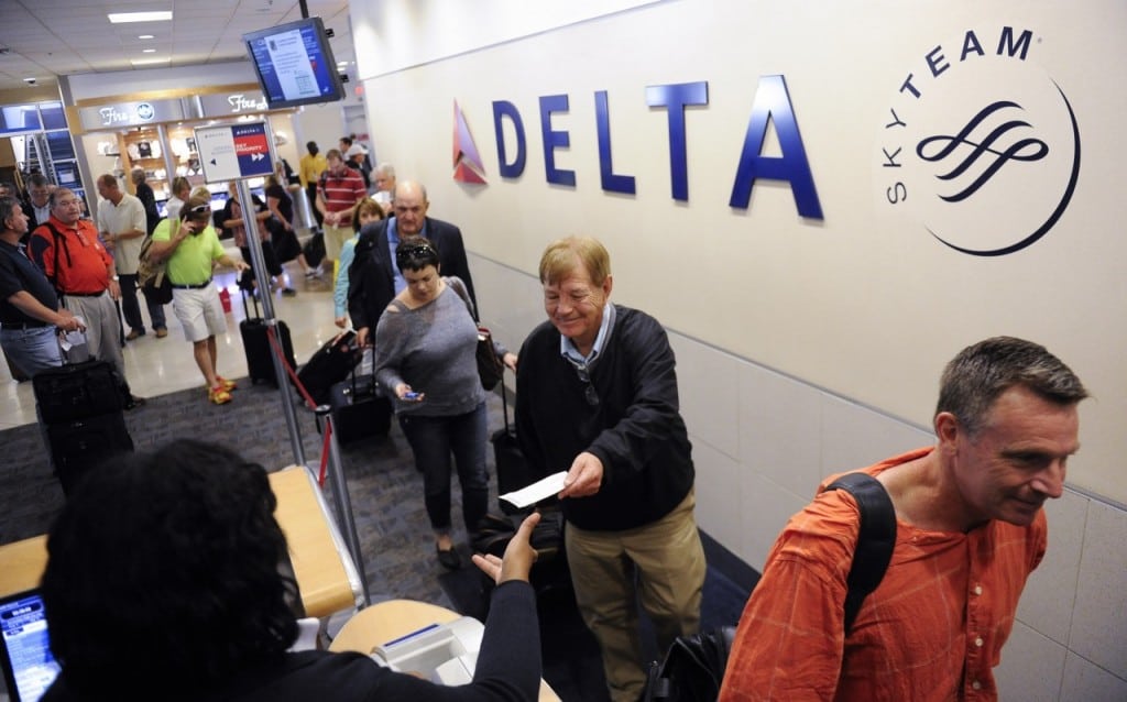 In this Friday, Sept. 27, 2013, photo, Delta Air Lines passengers, who have purchased an upgrade to board their flight early, take advantage of priority boarding as they make their way to their flight at Hartsfield-Jackson Atlanta International Airport in Atlanta.