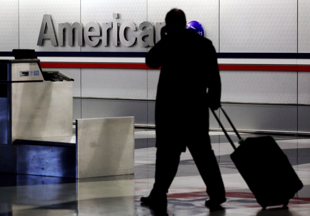 A passenger walks through an American Airlines baggage claim area at O'Hare International Airport in Chicago. 