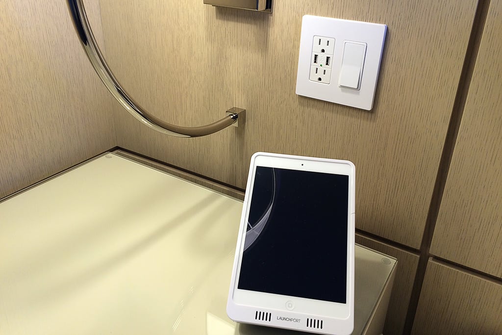 An iPad and USB plug on a bedside table at the Four Seasons Resort Orlando at Walt Disney World. 