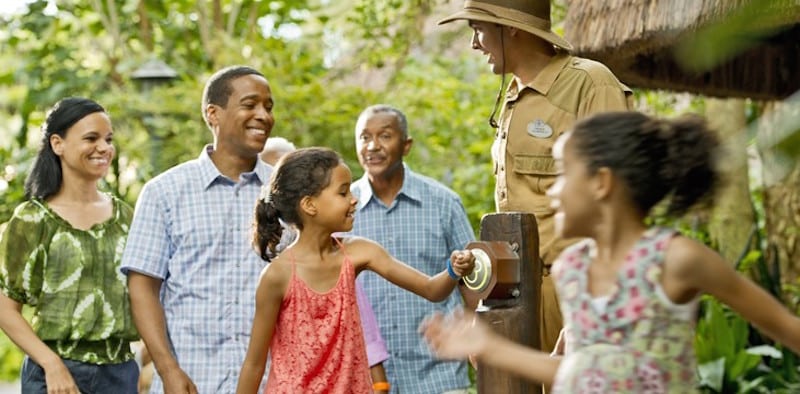 A family uses the MyMagic+ band in this promotional image from Disney. 