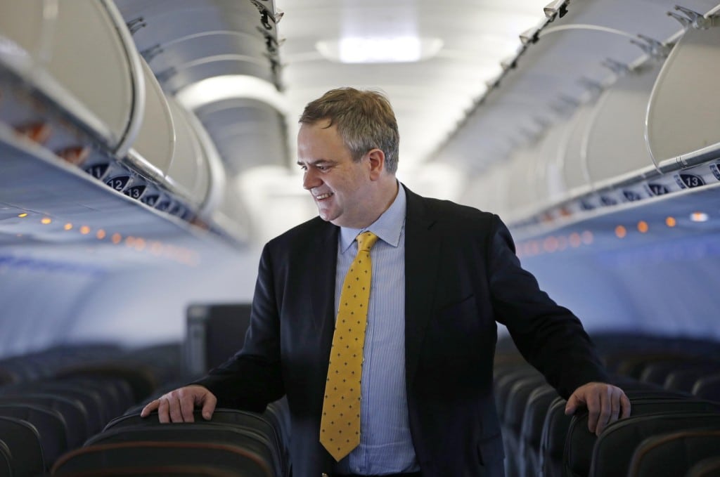 Robin Hayes walks through the aisle of a JetBlue plane at JFK airport in New York. JetBlue is evaluating its fleet mix as it considers whether to fly to Europe.