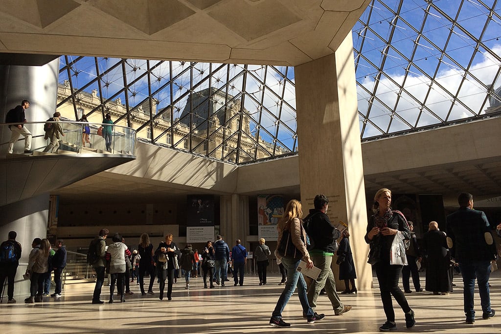 Tourists in the lobby of Paris' Louvre Museum.