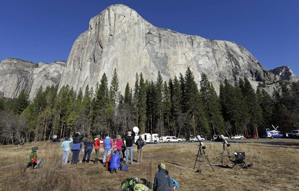 Spectators gaze at El Capitan for a glimpse of climbers Tommy Caldwell and Kevin Jorgeson, as seen from the valley floor in Yosemite National Park, Calif. 