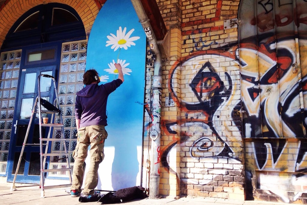 A man works on a mural in Gorlitzer Park in Berlin. 
