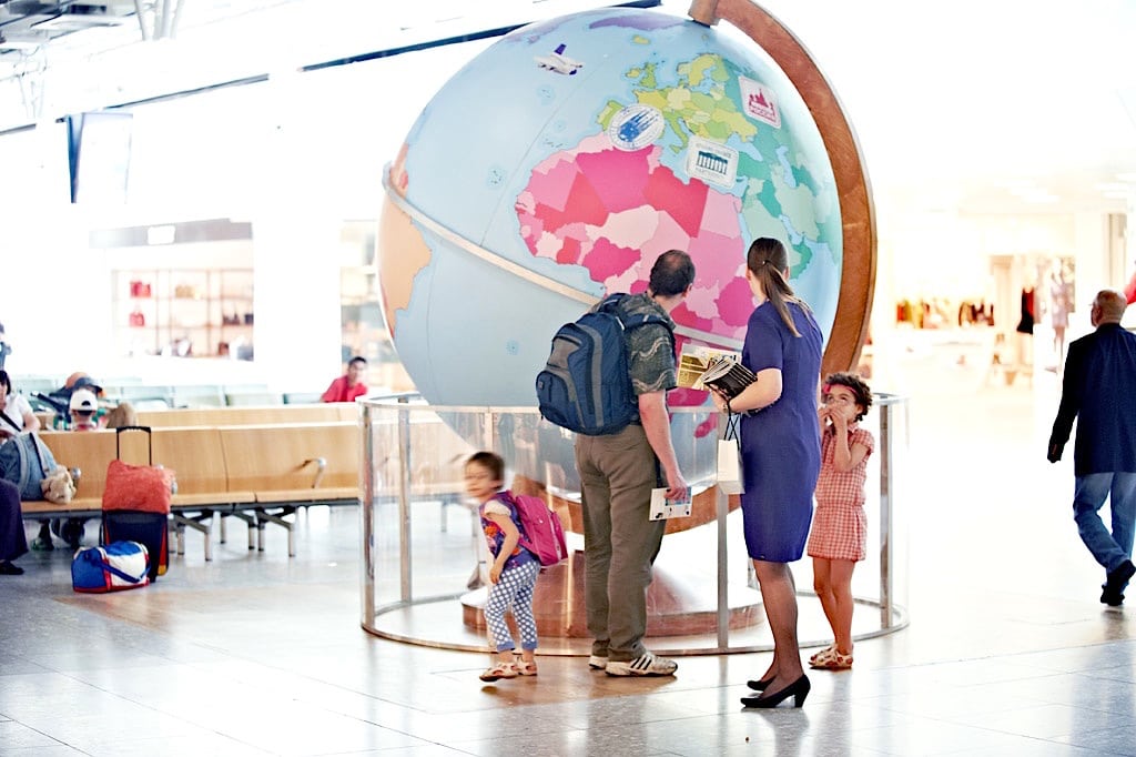 A family looks at the interactive giant globe set up in the departure lounge in Terminal 4 at Heathrow Airport in July 2012. 