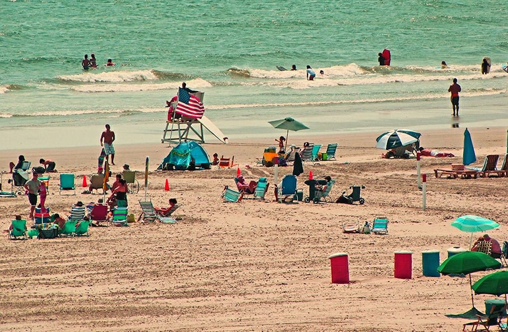 The fewer Americans who will take a vacation this year will spend more on those trips. Pictured is a a beach in Wildwood, New Jersey in August 2012. 