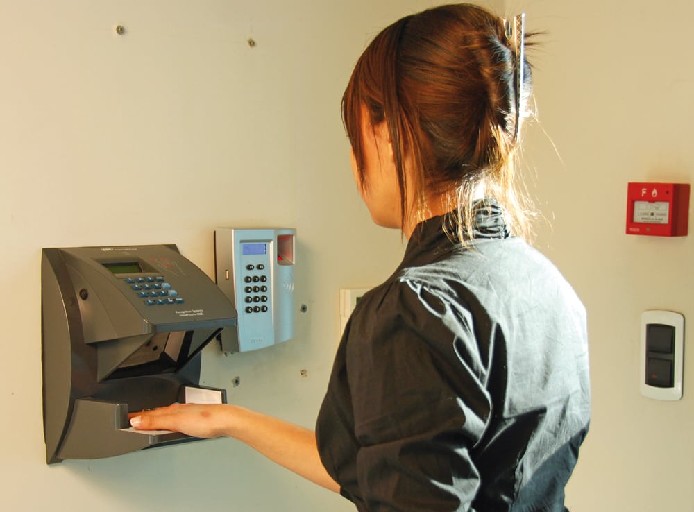 A Yotel employee using one of the hotel's new biometric handprint scanners for tracking employee attendance and monitoring shifts.