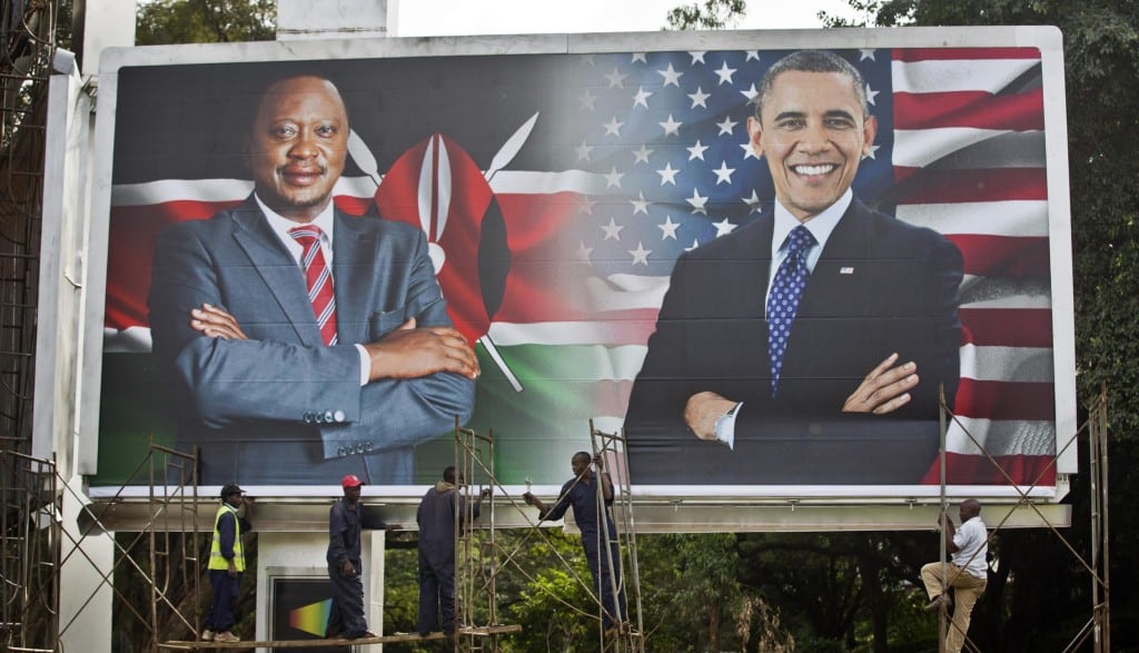 Workers finish installing a large billboard showing Kenya's President Uhuru Kenyatta, left, and President Barack Obama, right, in downtown Nairobi, Kenya Thursday, July 23, 2015. 