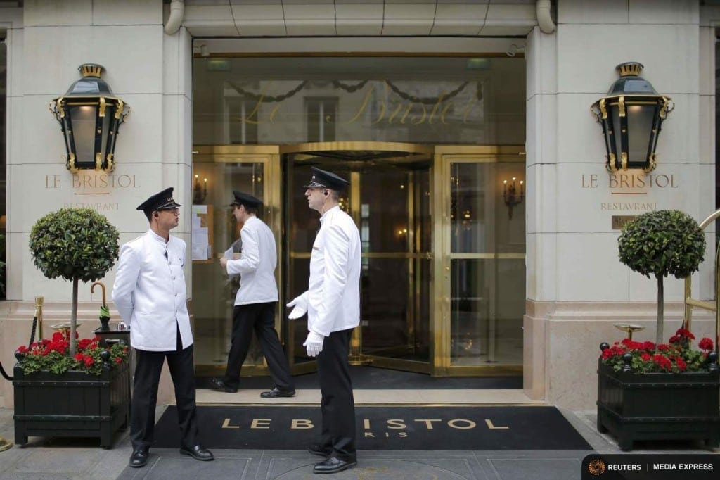 Employees wait for clients in front of the luxury hotel Le Bristol in Paris, France.