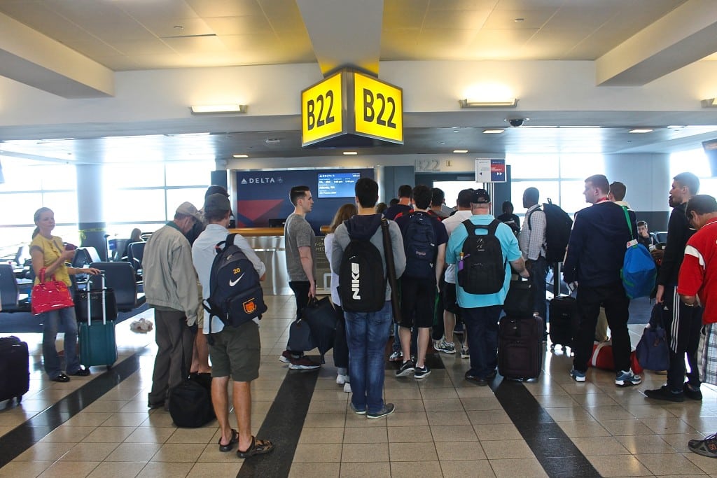 Travelers wait to board a Delta Air Lines flight at Terminal 4 at New York's John F. Kennedy International Airport.