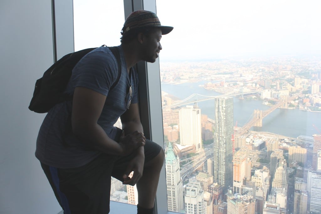 A traveler taking in the sites by himself at the new 1 World Trade Center Observatory in New York City.
