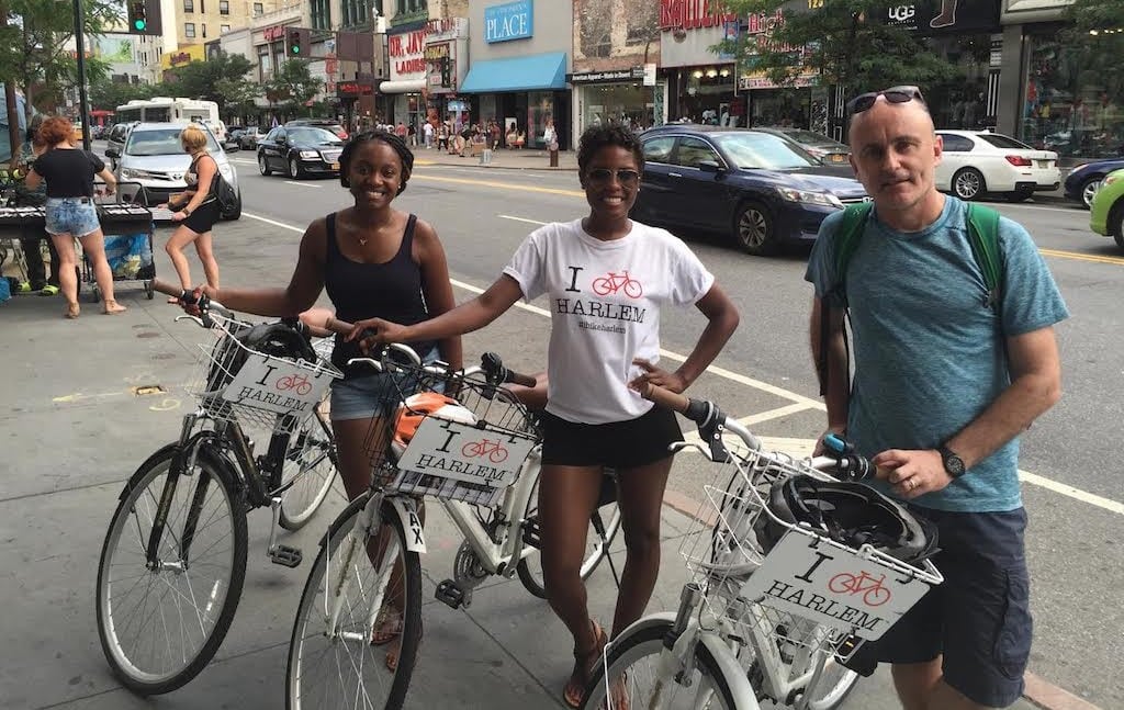 Maxine Daniels (center), founder of I Bike Harlem, with two Airbnb guests on a bike tour in Harlem, New York City. 

