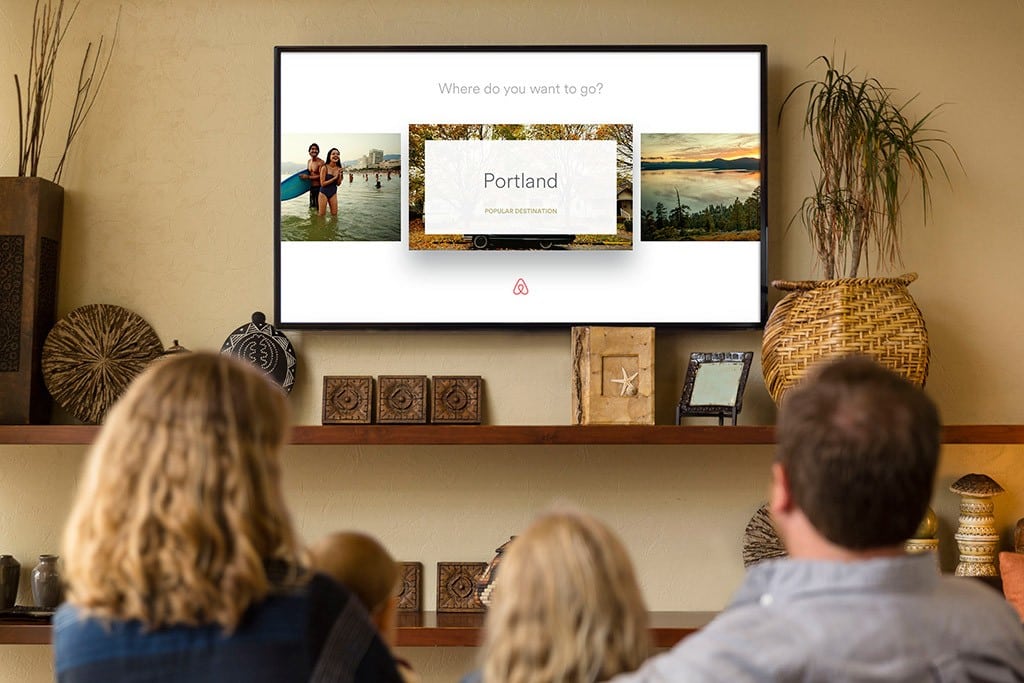 A promotional image from Airbnb of a family using its forthcoming Apple TV app. 