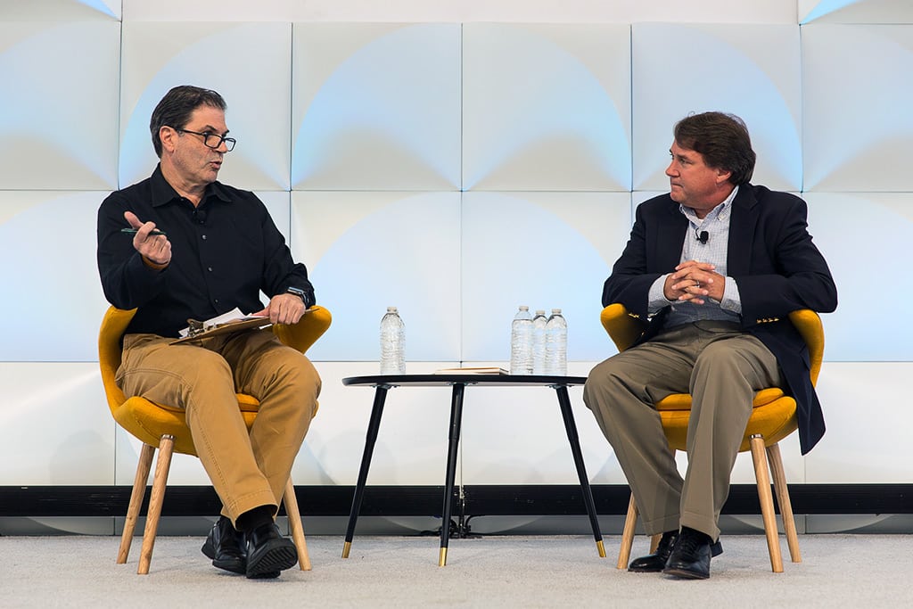 Paul Hennessey (right), CEO of Priceline.com and moderator Dennis Schaal, Skift's news editor, speaking at Skift Global Forum in Brooklyn, New York on October 14, 2015.