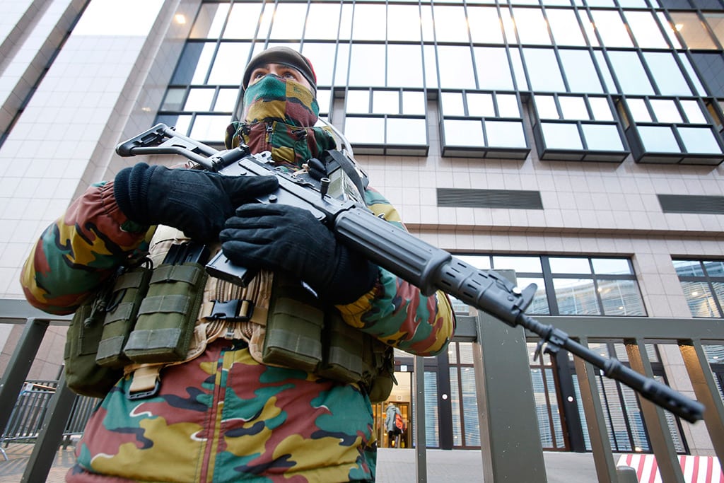 A Belgian police officer guards the building of the European Commission in Brussels, Belgium, Tuesday, Nov. 24, 2015. 
