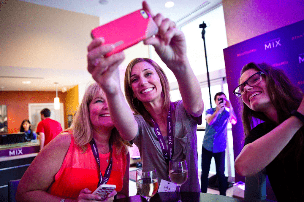 Marriott.com wants to be known as a value-oriented and mobile-savvy brand. In Google Hotel Ads, Marriott.com markets itself the blurb, 'Best Rate Guaranteed. Mobile Check-In.' Pictured are some Residence Inn guests, including one with a smartphone, enjoying The Mix social gathering. 