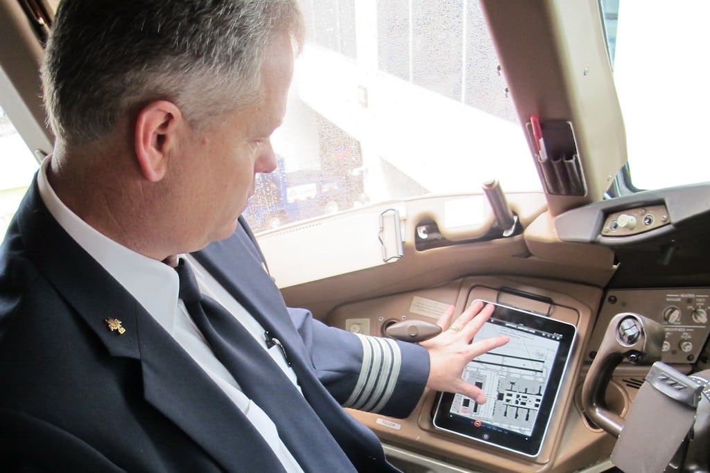 An American Airlines pilot demonstrates an electronic flight bag on an iPad. More than 90 percent of U.S. airline pilots were white men in 2015.