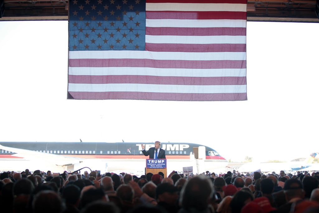 Republican Presidential candidate Donald Trump gives a speech in front of his private jet at a Mesa, Ariz., airport. 
