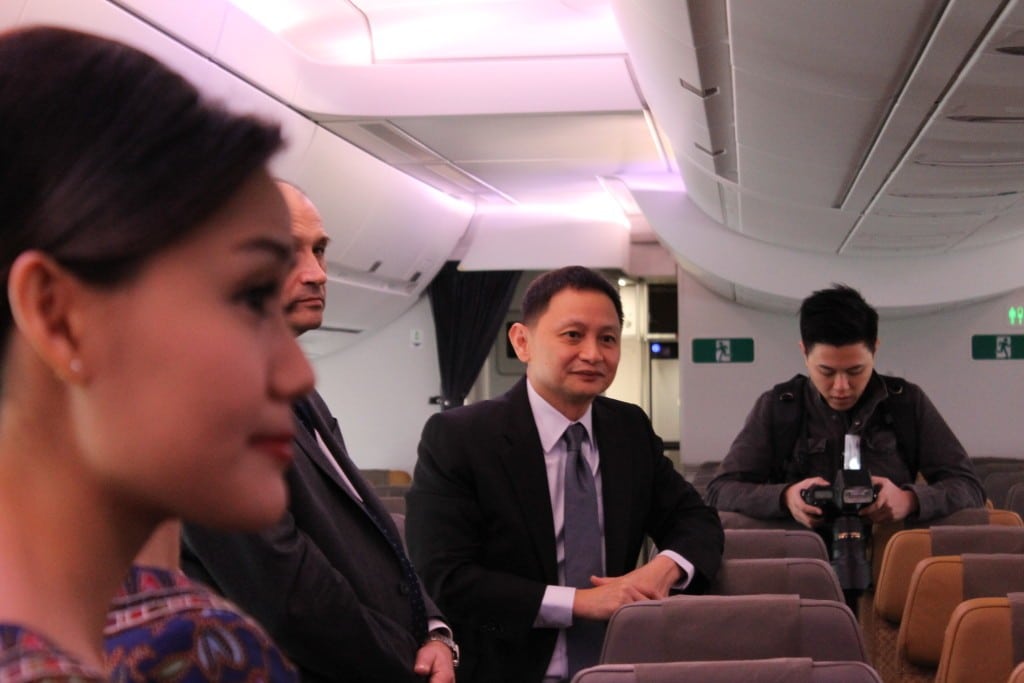 Singapore Airlines CEO Goh Choon Phong (center), speaking on board a delivery flight in Toulouse, France earlier this year, wants to diversify its low-cost carrier portfolio for U.S. and European expansion.