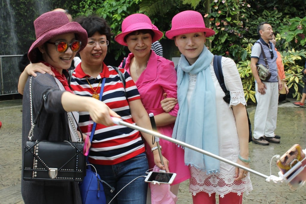Chinese travelers taking a selfie at Gardens by the Bay in Singapore.