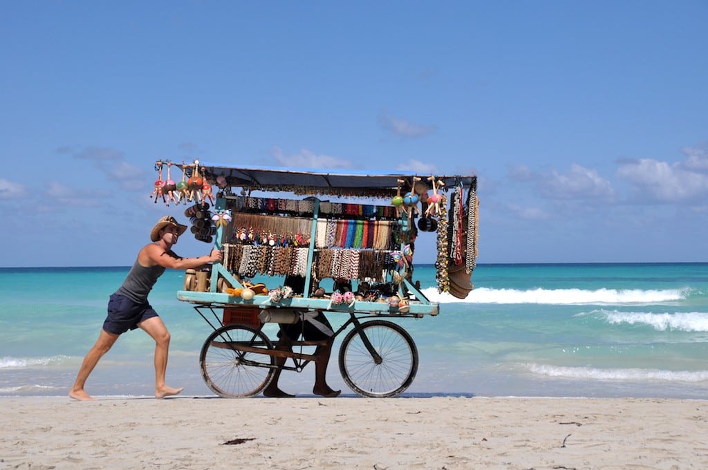 A traveling salesman on the beach in Cuba.