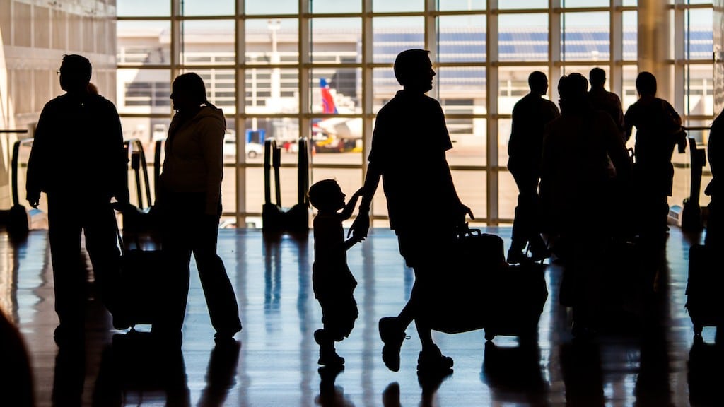 A family walks through an airport in Michigan.