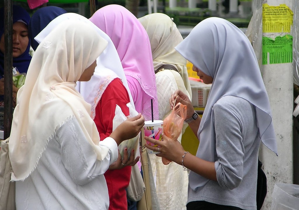 A group of Muslim travelers queueing for food in Kuala Lumpur, Malaysia. 