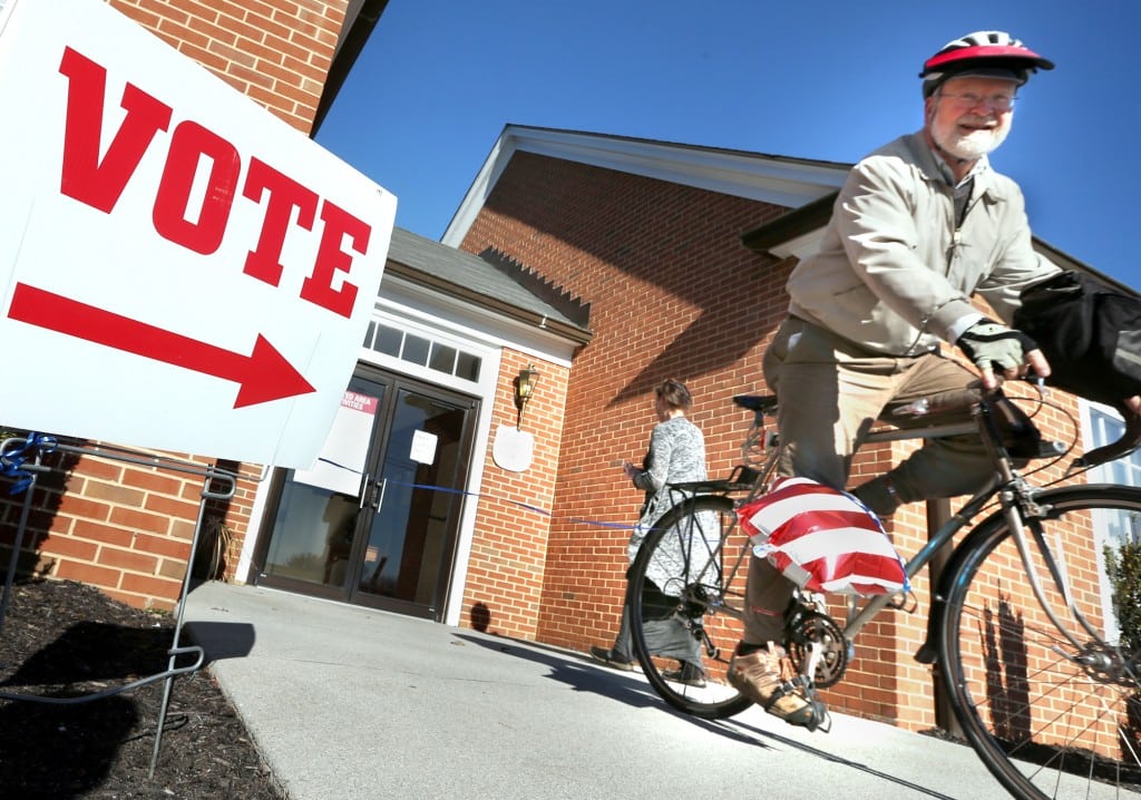 David Ray rides his bike away from his polling place after voting in the primary election Tuesday, March 1, 2016 in Winchester, Va. 