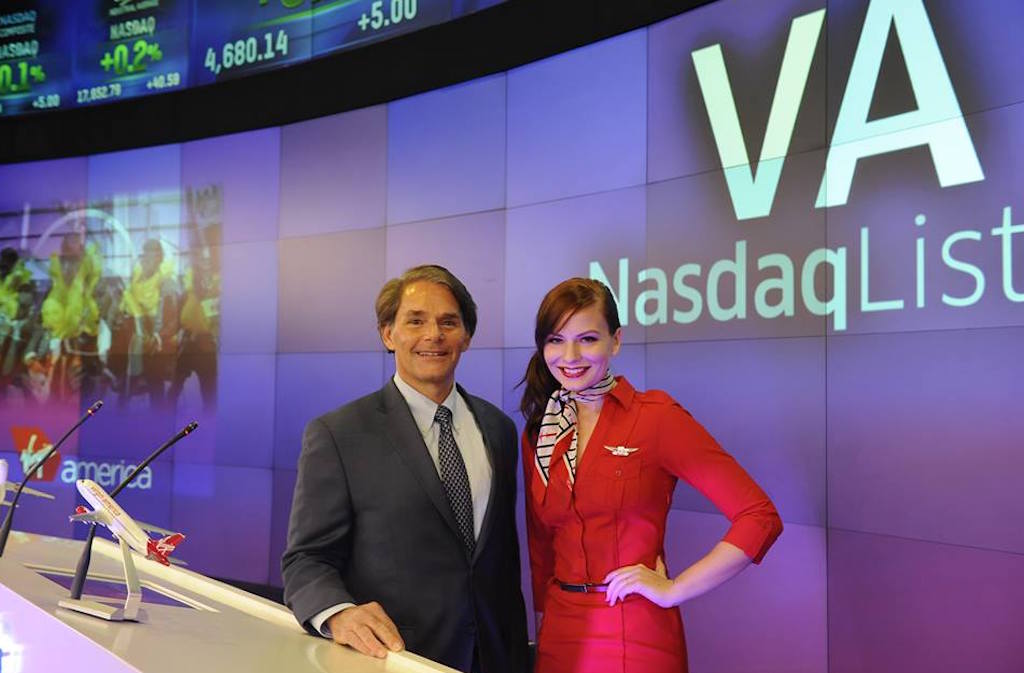Virgin America CEO David Cush and a flight attendant mark the airline's IPO at the Nasdaq exchange on November 14, 2014.