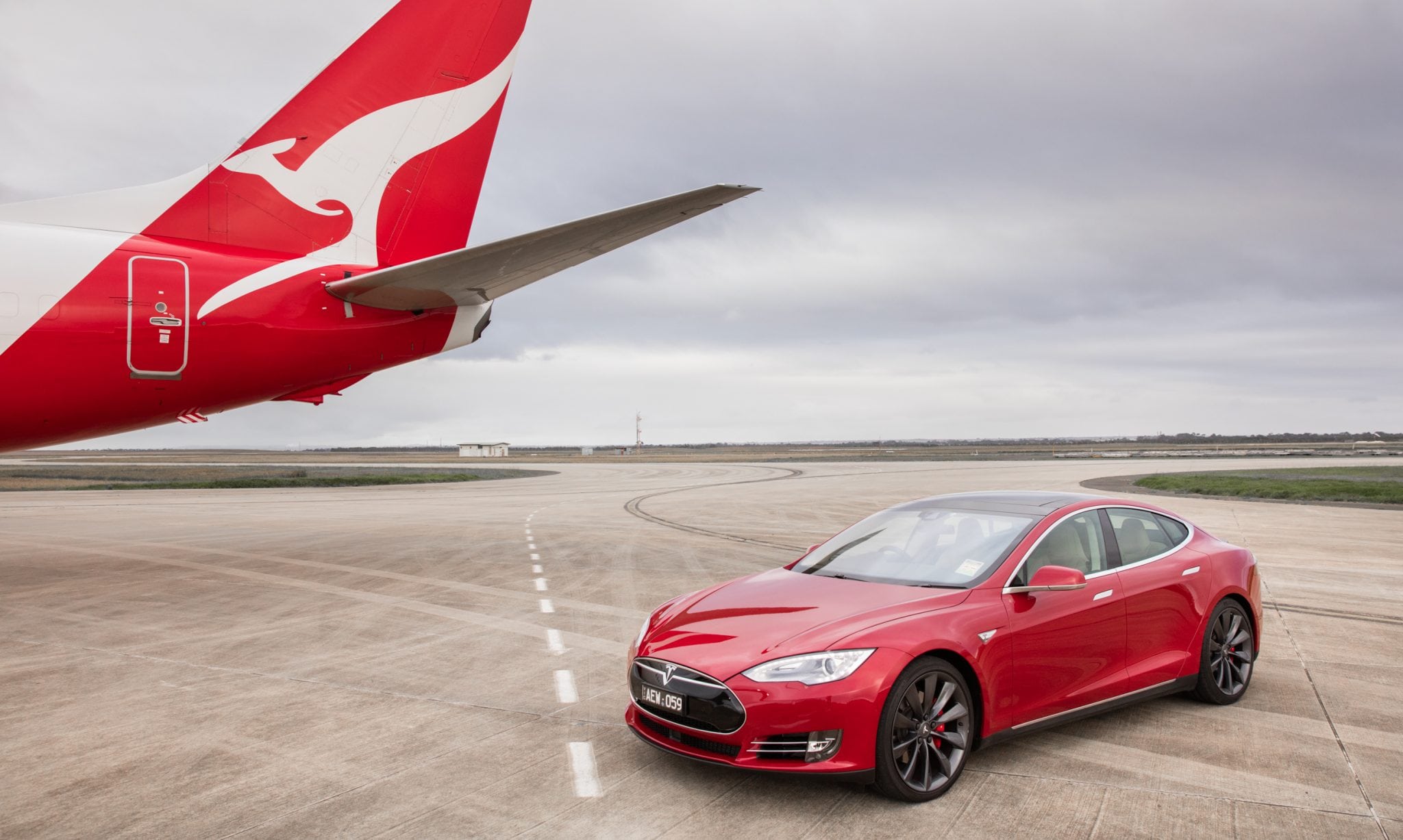 A Qantas Boeing 737 races a Tesla Model S to mark launch of new sustainability collaboration.  