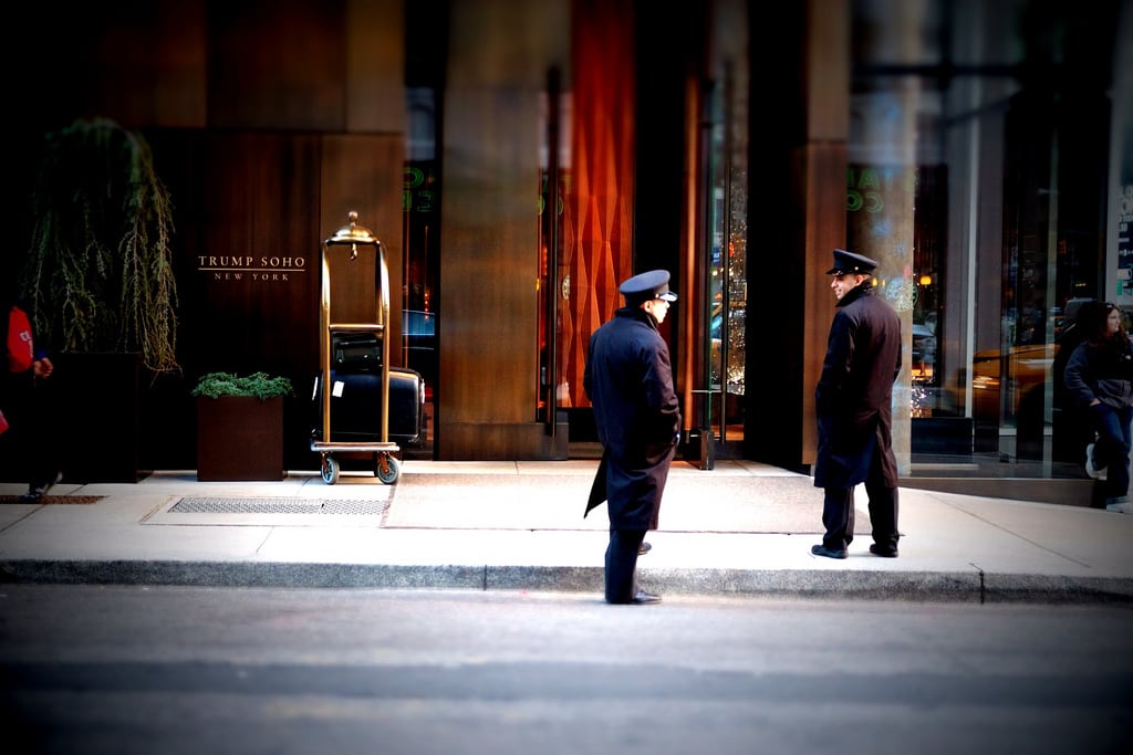 Bellmen outside the Trump SoHo in New York City, NY. U.S. Trump-branded properties' share of foot traffic has been falling since Trump began his presidential campaign last year.