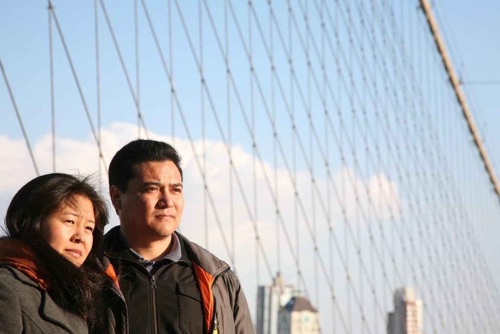 Chinese tourists on the Brooklyn Bridge in New York City. 