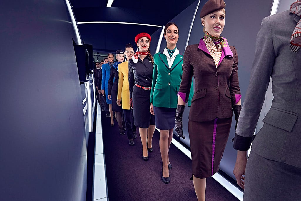 Flight attendants from Etihad Airways and partners in a promotional image celebrating the airlines' sponsorship of fashion events. 