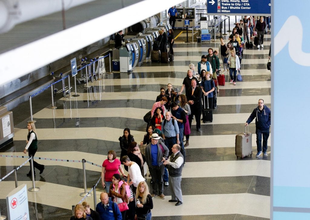 Long airport lines could be back if the TSA has its budget cut. A long line of travelers wait for the TSA security check point at O'Hare International airport, Monday, May 16, 2016, in Chicago.