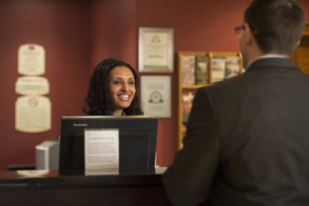 A promotional image of a Marriott front-desk employee. Upon the completion of its merger with Starwood, the combined company will have more than 500,000 employees. 