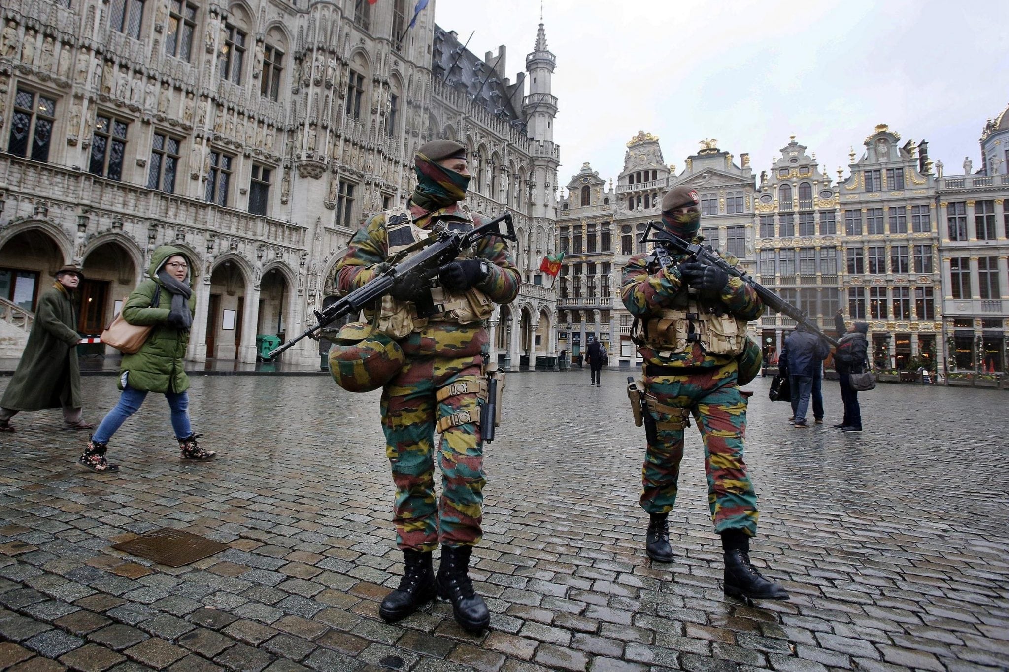 Police officers patrol Brussels in November of 2015. A new study shows a majority of employers offer travel insurance and assistance to business travelers.