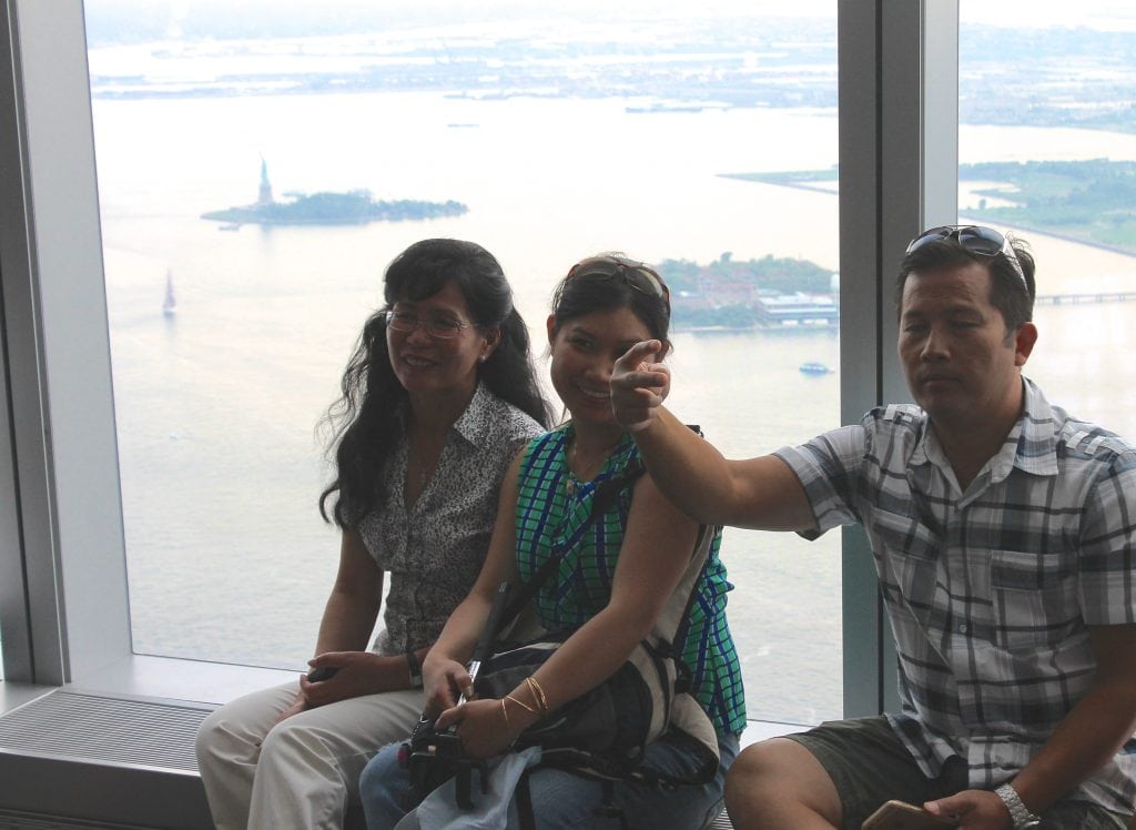 Travelers enjoy the sights from the 1 World Trade Center Observatory in New York City. International visitor spending in the U.S. is up even with several unfavorable exchange rates for visitors.