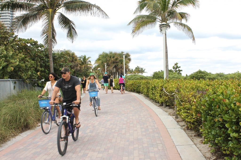 Travelers ride Citi Bikes along a beach in Miami. International travel to the U.S. had another record year in 2015 with 77.5 million visitors.