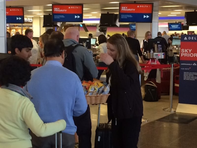 A Delta employee helping passengers at Seattle Tacoma Airport after its global outage August 8, 2016.