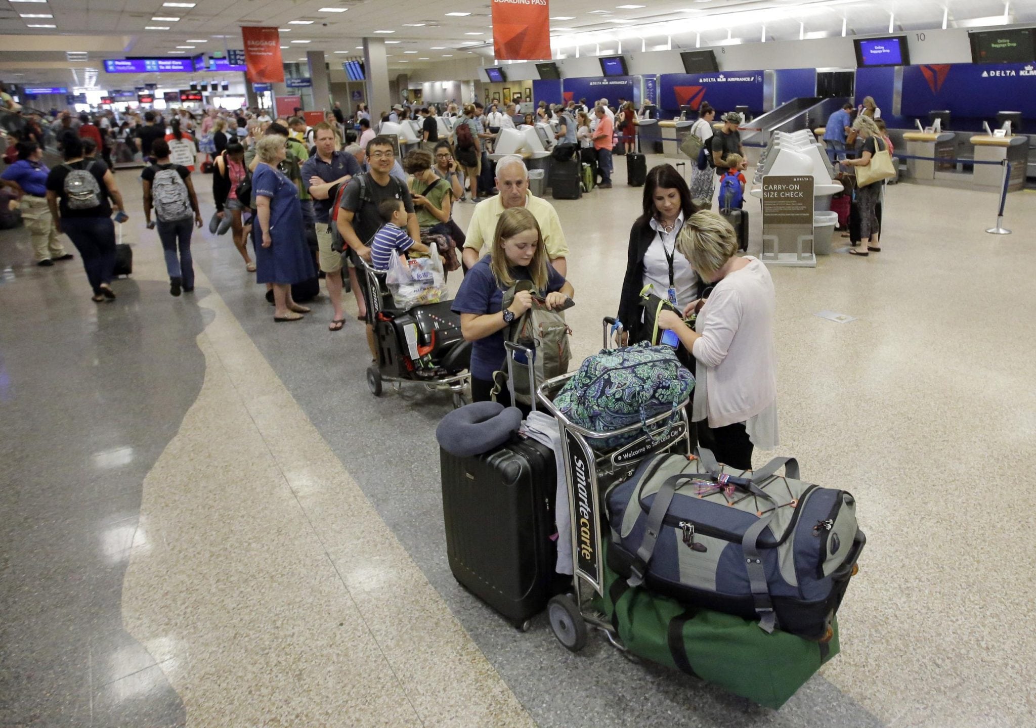 Delta passengers wait Tuesday at Salt Lake City International Airport. New developments make it difficult for Delta to rebook passengers on other airlines. 