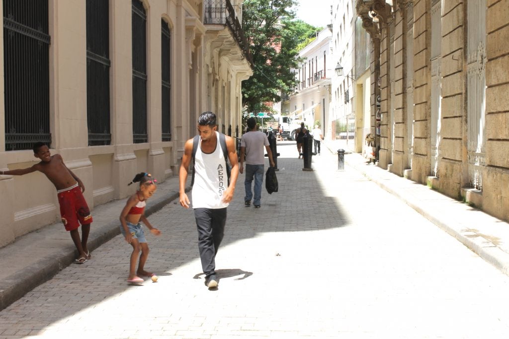 Travel brands are having trouble showing how to live like a local on social media. Pictured is a family playing on a street in Havana, Cuba, a common activity among locals throughout the city.