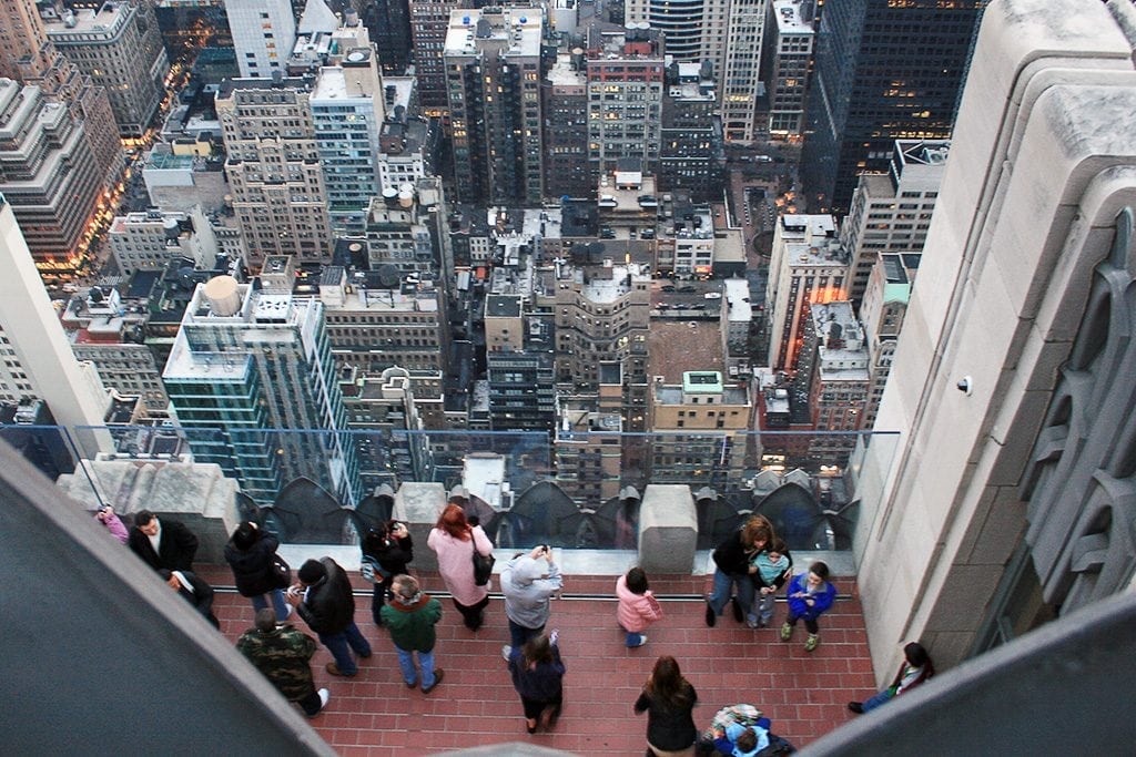 Most of the top places tourists visit in New York City are, unsurprisingly, iconic tourist attractions. Pictured here are tourists at the observation deck of Rockefeller Center. 